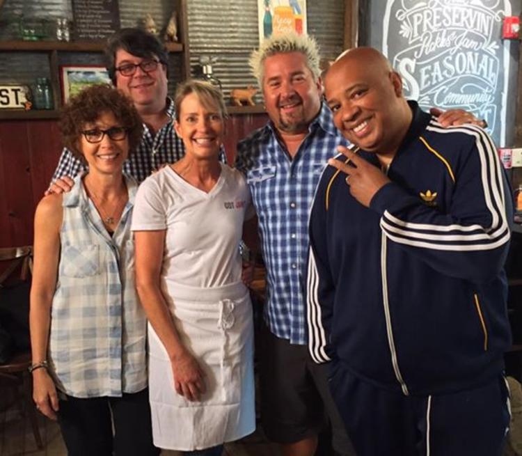 The women and men who own Jammin Crepes pose with the famous food critic and TV personality Guy Fieri.