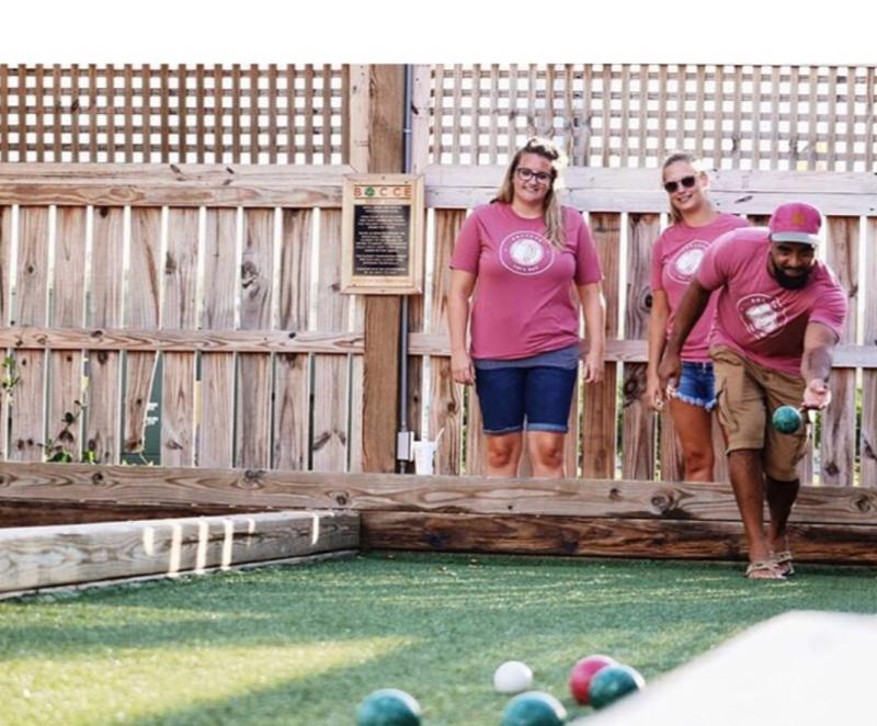 Two women and a man playing Bocce at The Shack