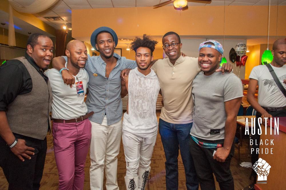 Men posing for a photo at an event for Austin Black Pride