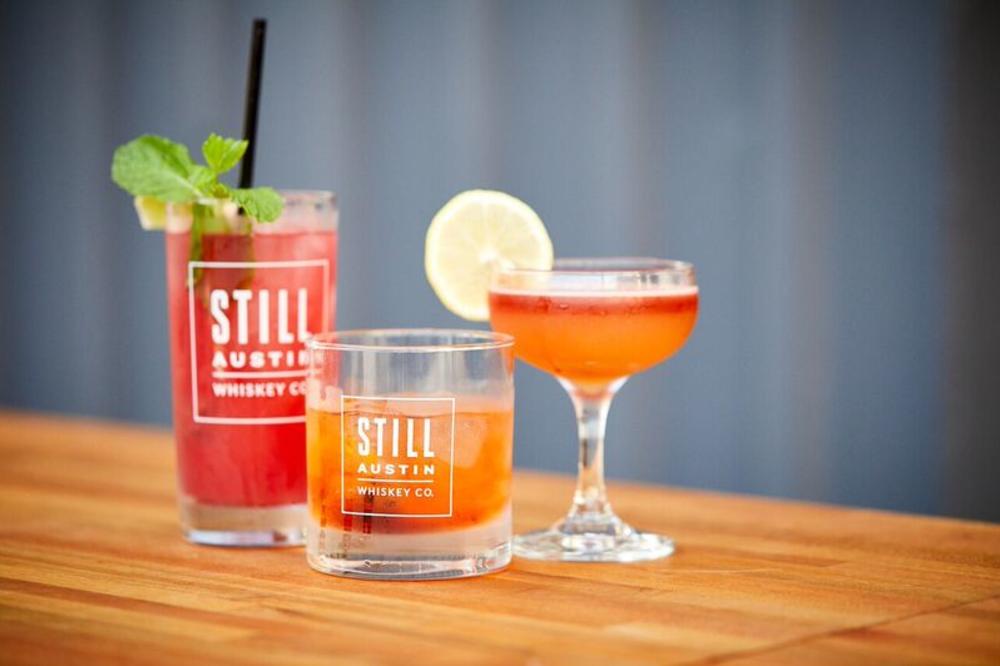 Mixed drinks with Still Austin Whiskey Co logo on glasses