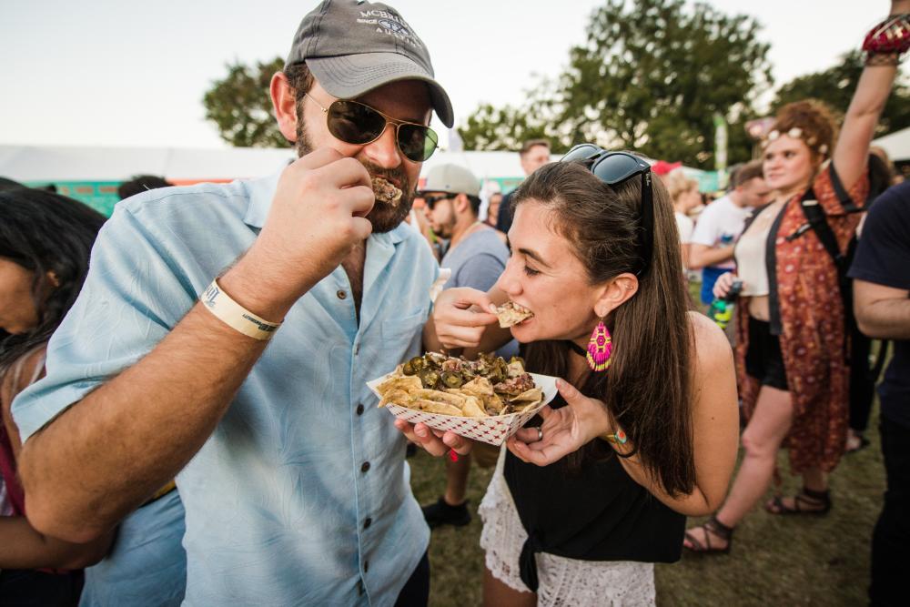 Man and woman sharing Sloppy Nachos from Salt Lick BBQ at ACL Eats at Austin City Limits Music Festival