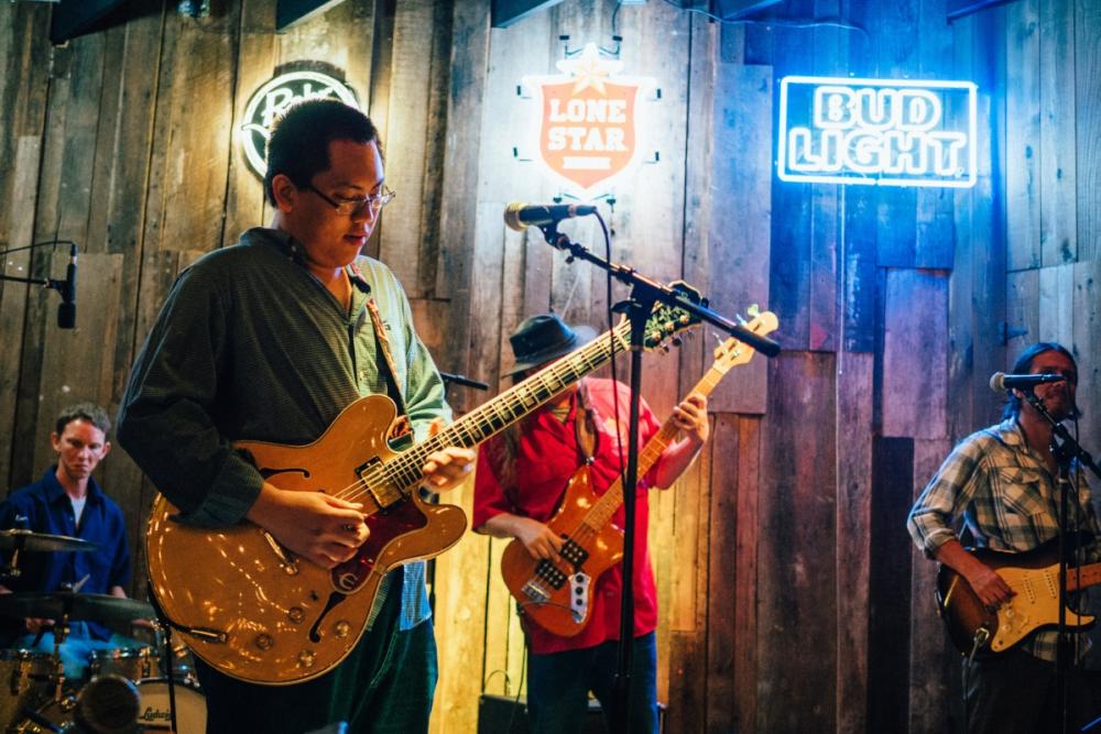 Band on stage at Rustic Tap bar on west sixth street in austin texas