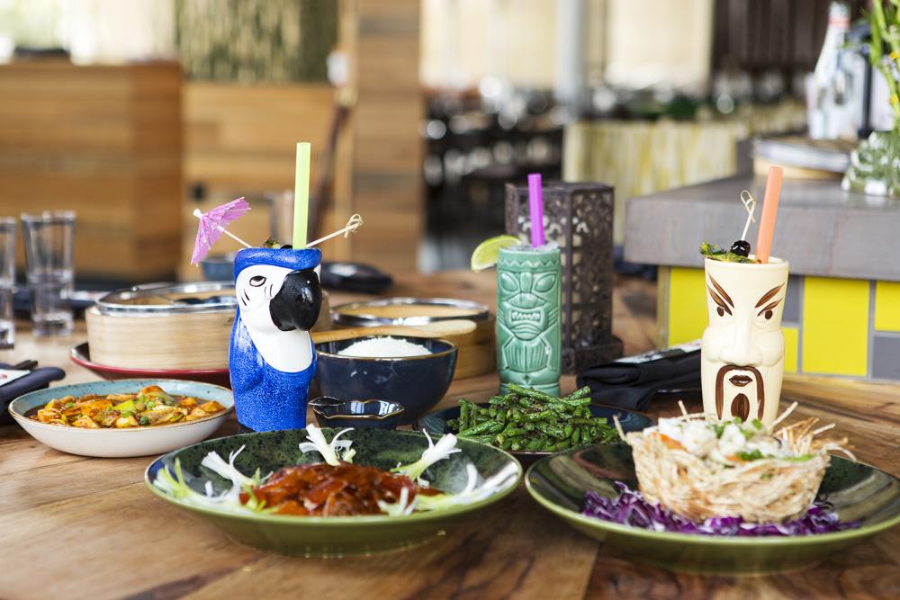 Table spread at Wu Chow including beverages in colorful tiki glasses