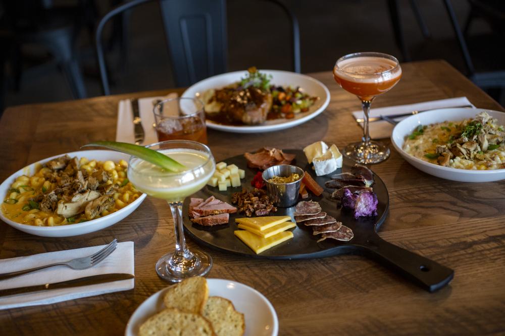 Dining Table Full of Food at Three Rivers Distilling Company in Fort Wayne, Indiana for Savor Fort Wayne