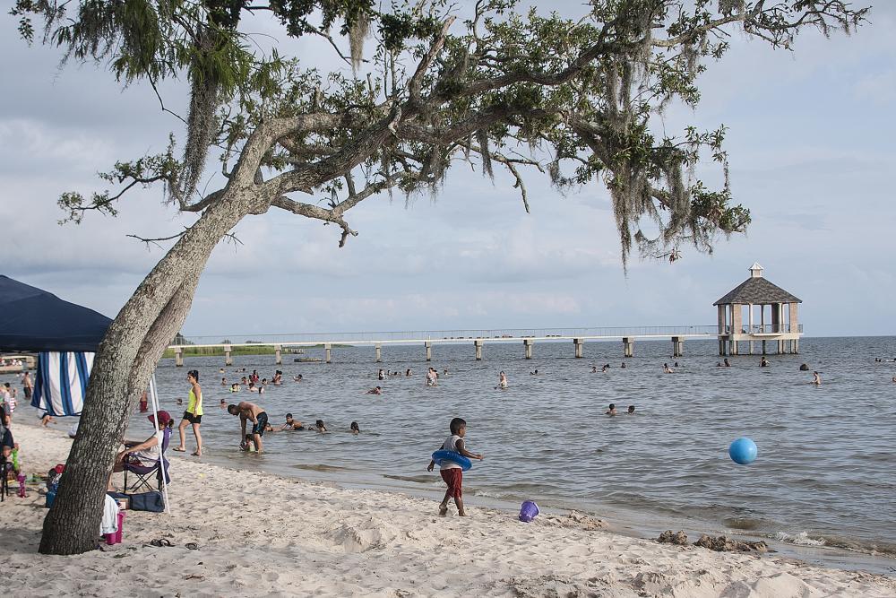 Visitors play on the beach at Fontainebleau State Park in Mandeville
