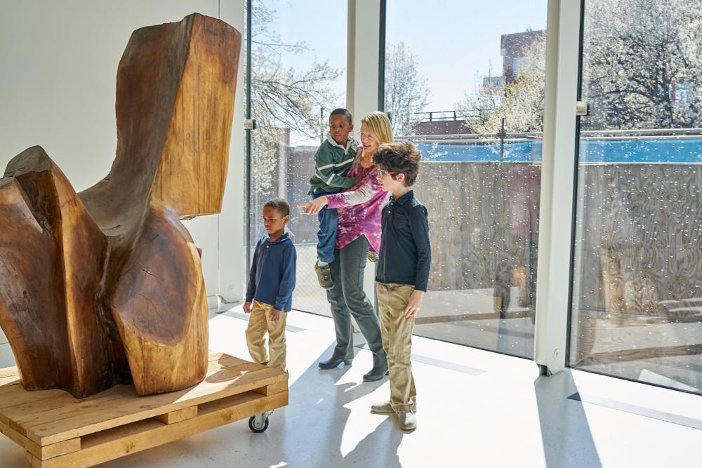A family explores an exhibit at the Asheville Art Museum