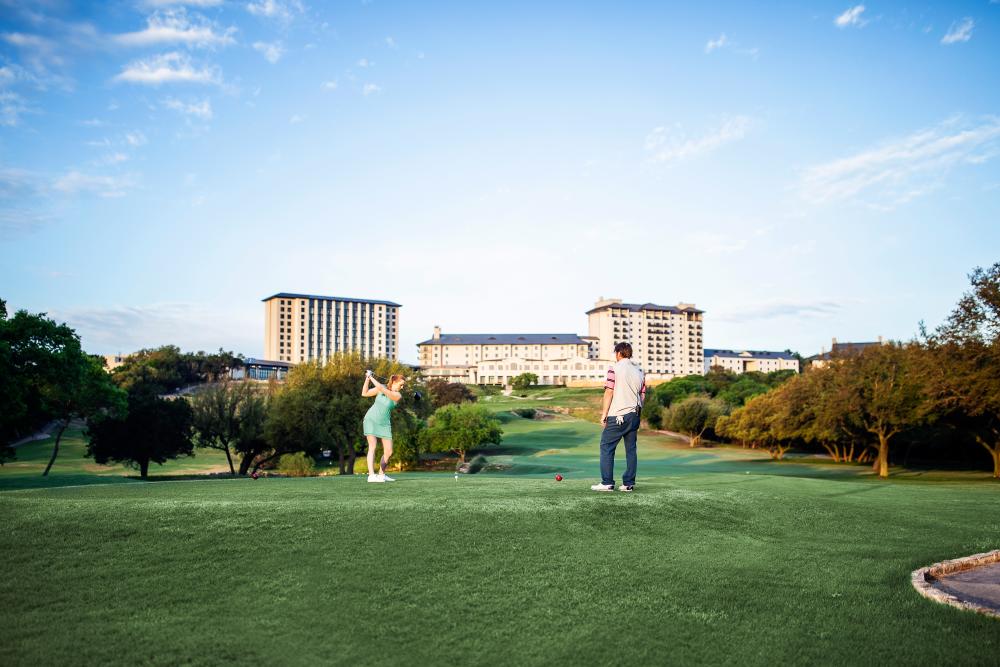 Couple playing on the Golf Course at Omni Barton Creek Resort and Spa in austin texas