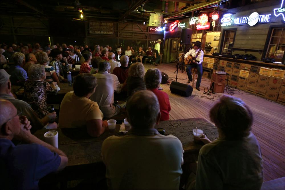Performer with guitar on stage at Gruene Hall