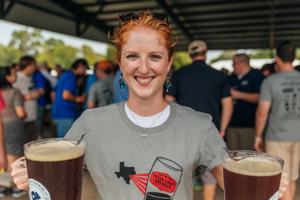 Volunteer with two pitchers of beer at Texas Craft Brewers Festival
