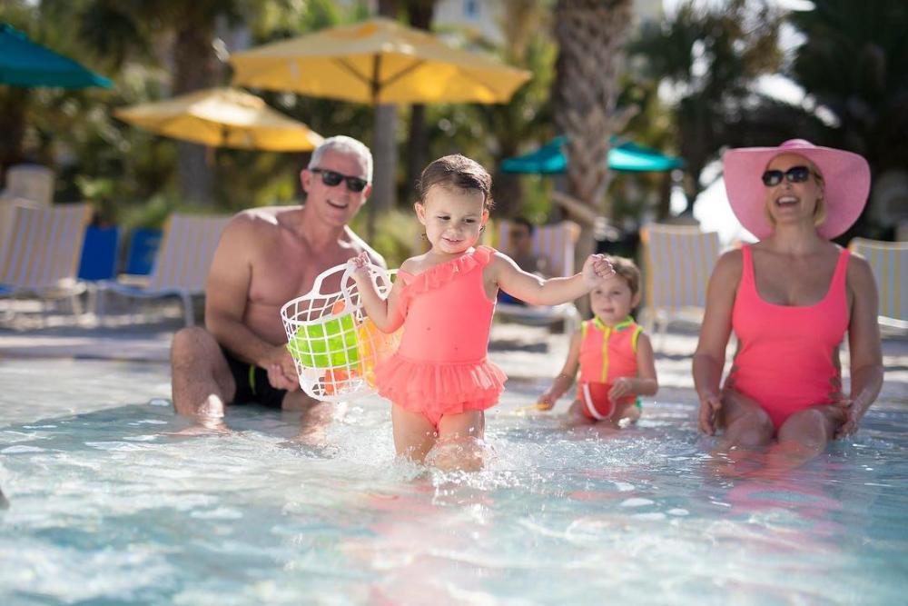 Family in a pool at Hammock Beach Resort in Flagler Beach