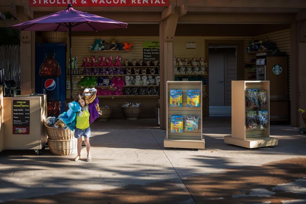 A little girl purchasing souvenirs at a Gift Kiosk in the Fort Wayne Children's Zoo in Indiana