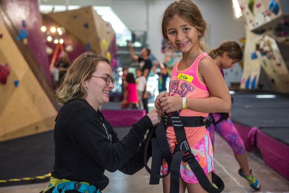 instructor with kid at Crux Climbing Center rock gym