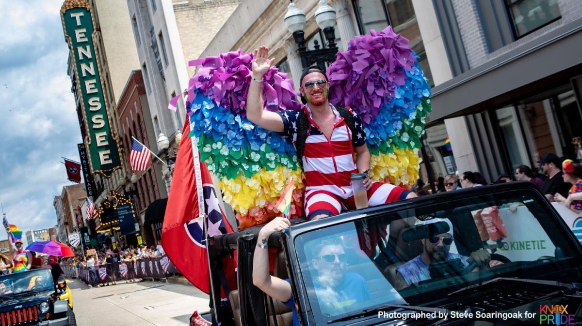 Justin Foster riding on top of a Jeep with the rest of The Edge Knox crew in the 2018 Knox Pride Parade courtesy of Steve Soaringoak