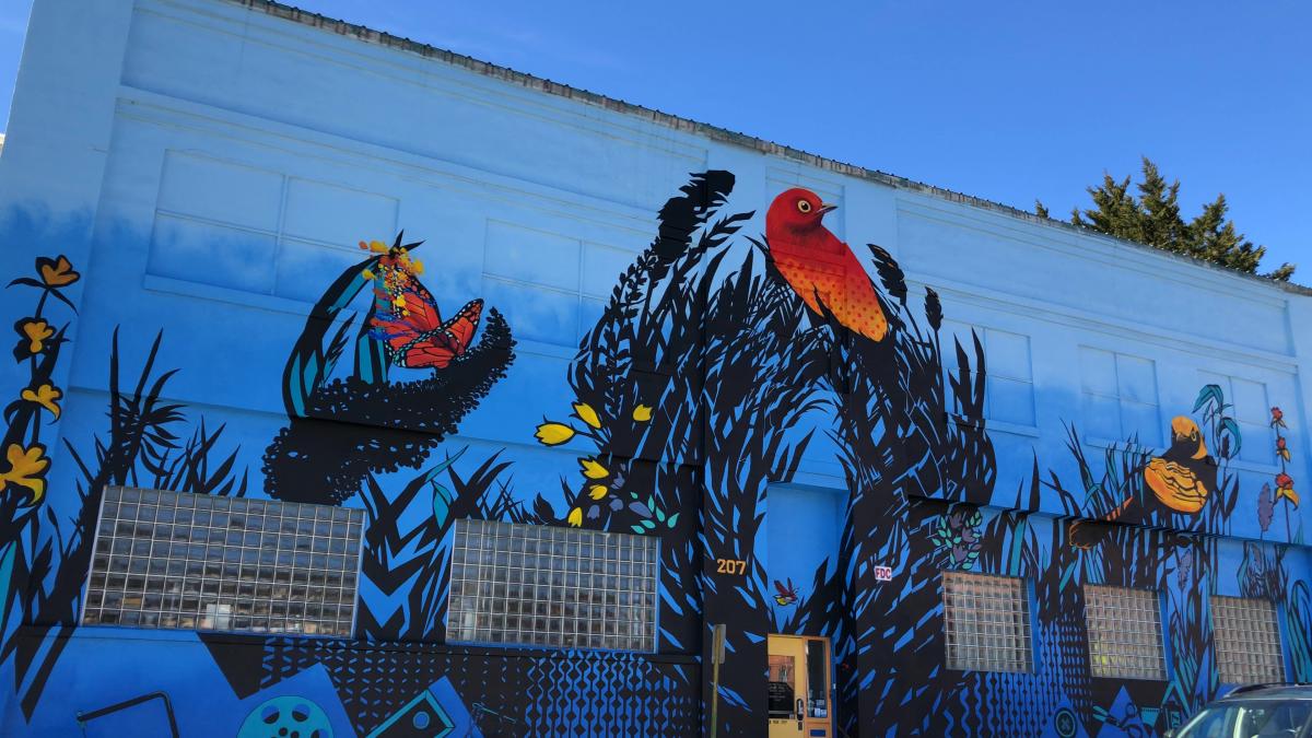 A colorful mural beckons guest to the Refinery Creator Space in Asheville, NC