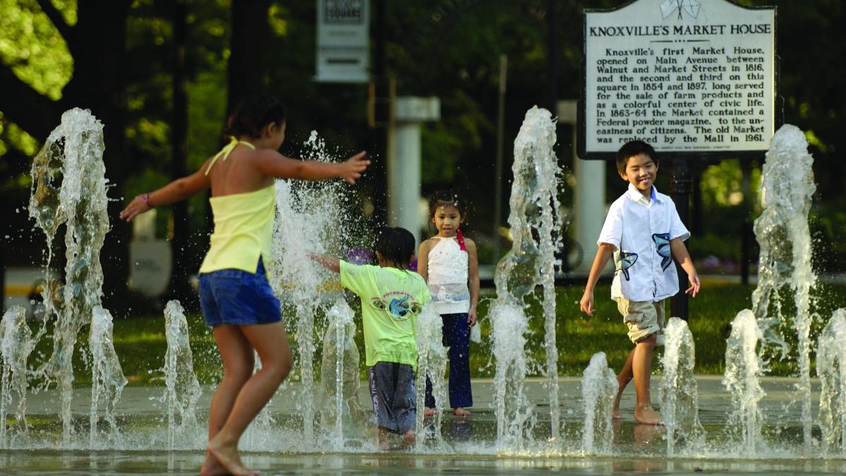 kids playing in a fountain in market square in Knoxville, TN