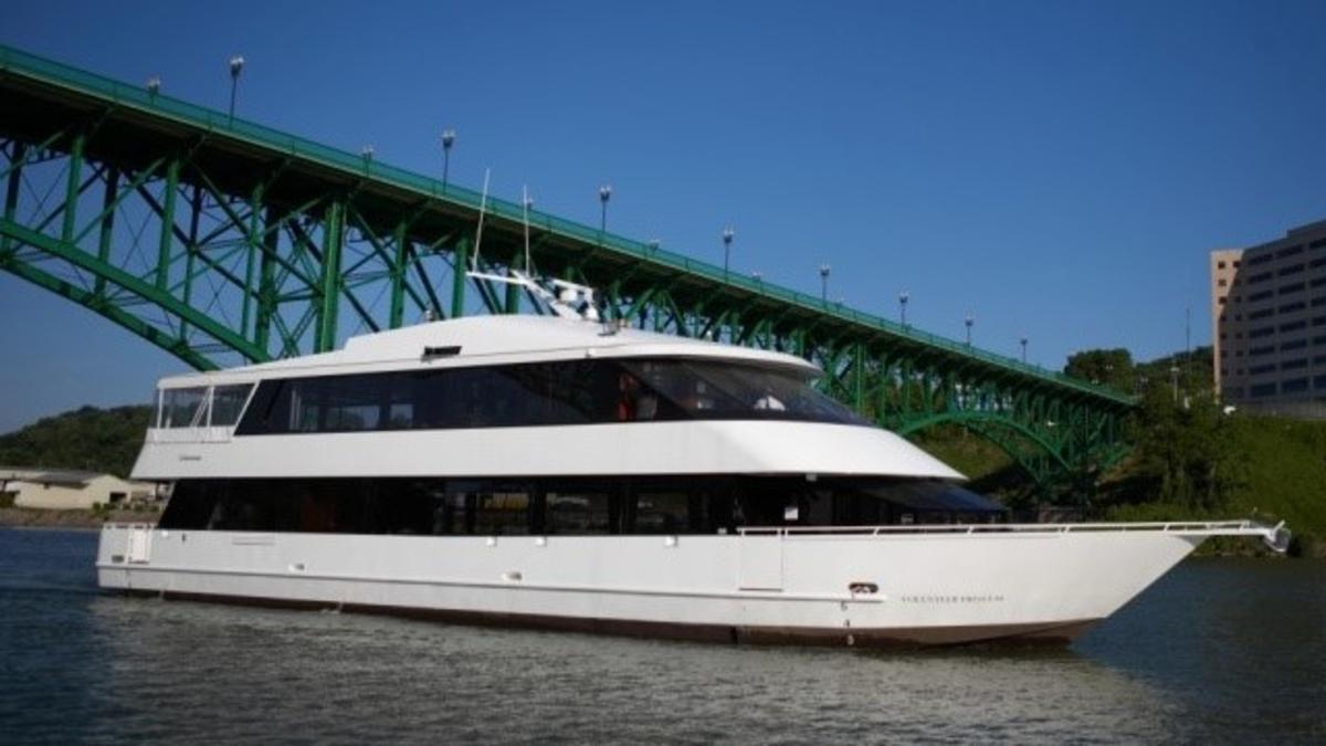 Luxury Yacht Cruising in the Water Under a Bridge