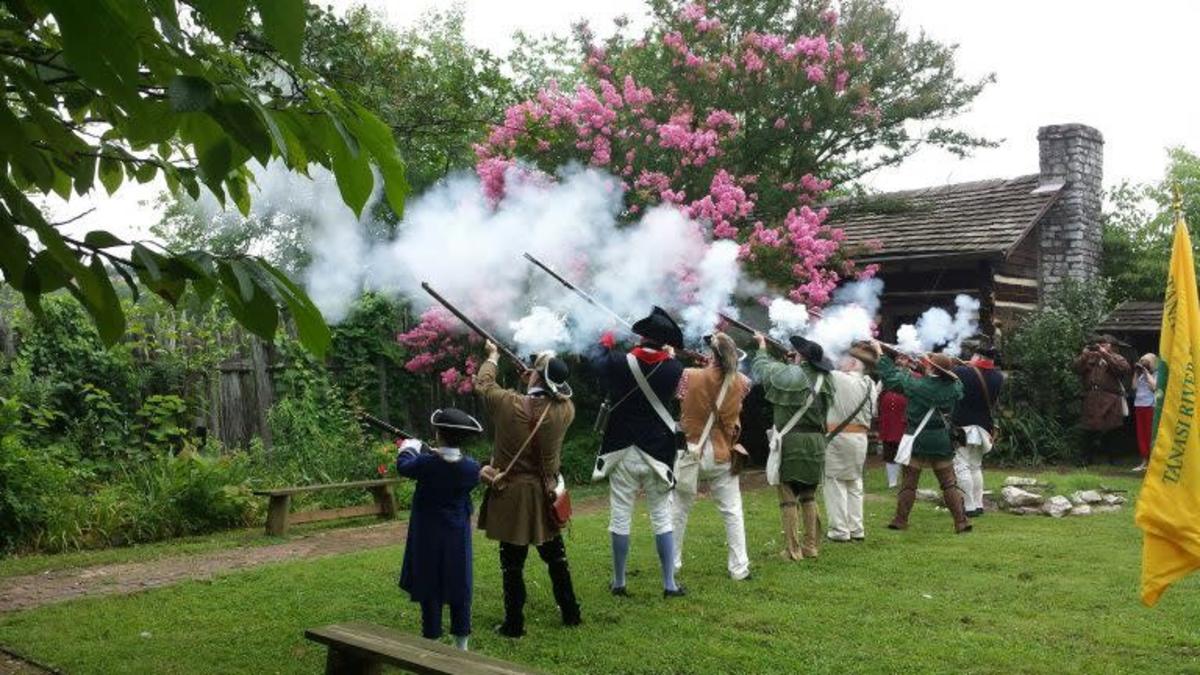 Men in Colonial Outfits Firing Guns in the Air at the James White Fort