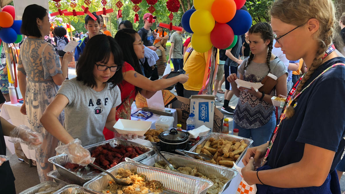 Two teens getting food at a festival