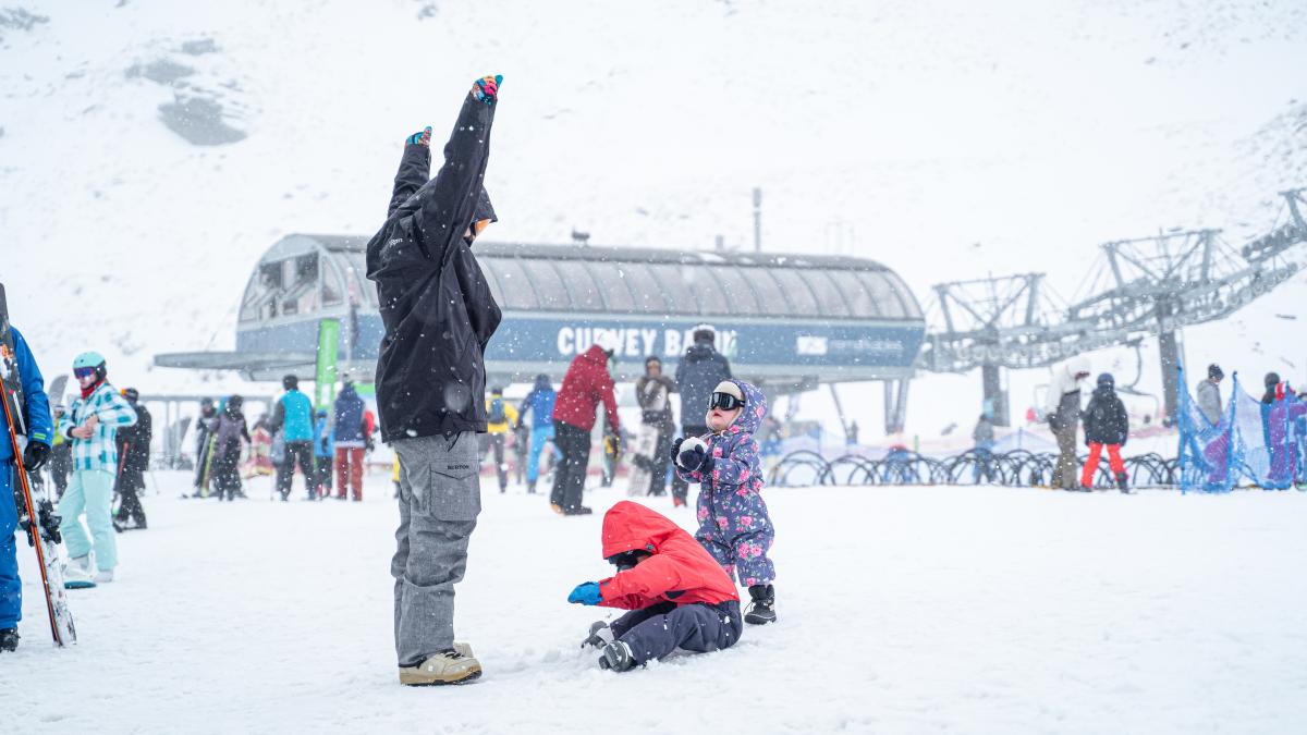 Family having fun in the snow at The Remarkables