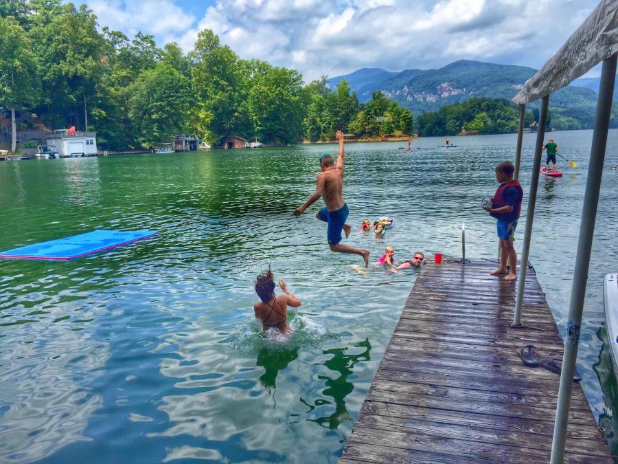 A group of friends jumping into Lake Lure, NC