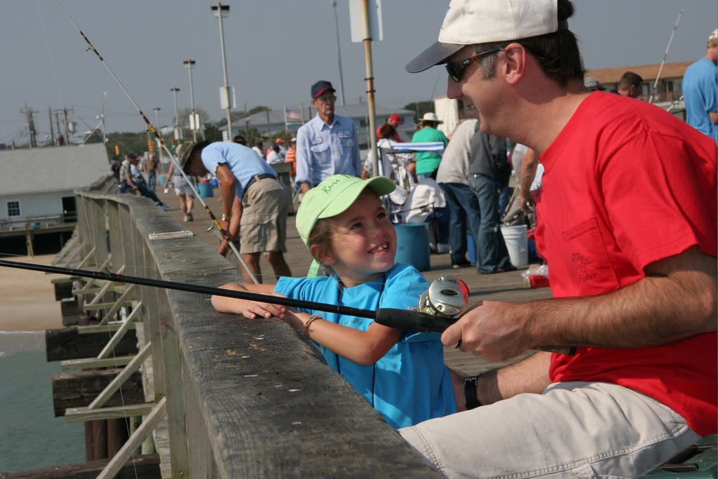 Father and daughter fishing off the Kure Beach Fishing Pier
