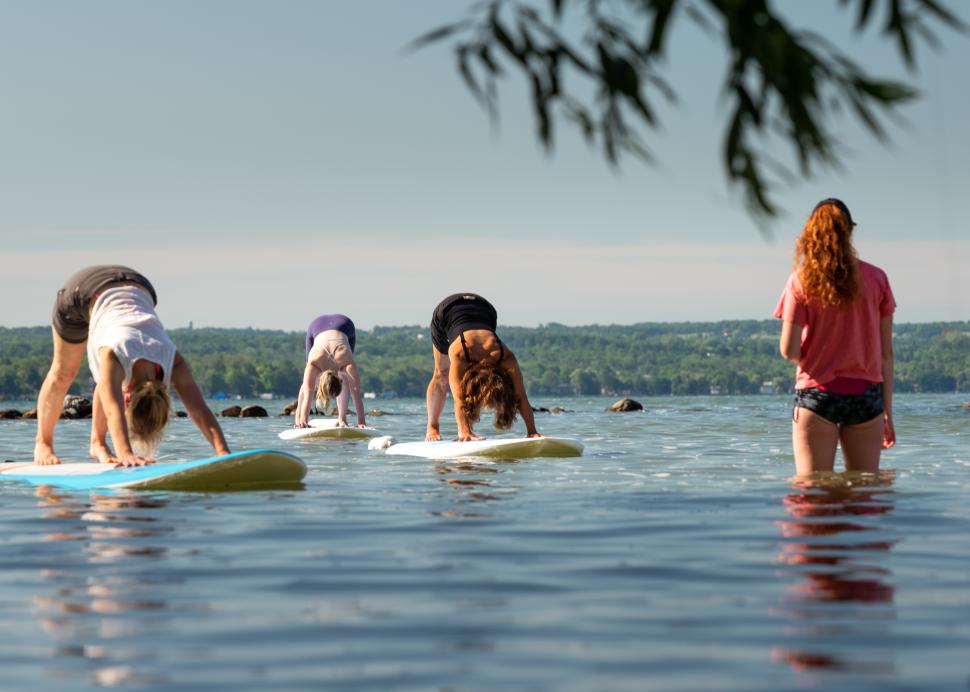 People doing yoga on paddleboards