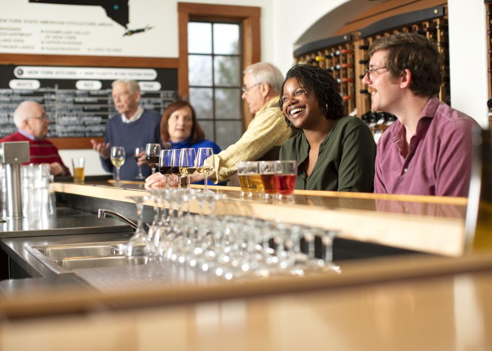 People drinking inside tasting room at New York Kitchen; Photo Credit: Grant Taylor Photography
