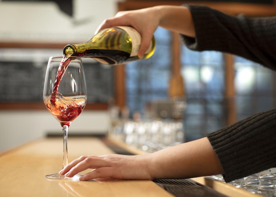 Wine being poured into a glass at New York Kitchen; Photo Credit: Grant Taylor Photography