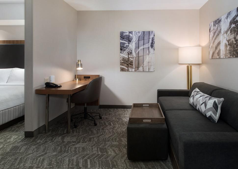 Our guest rooms feature a living area with sofa bed and work desk