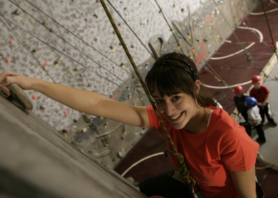 Young woman climbing at RockVentures in Rochester, NY
