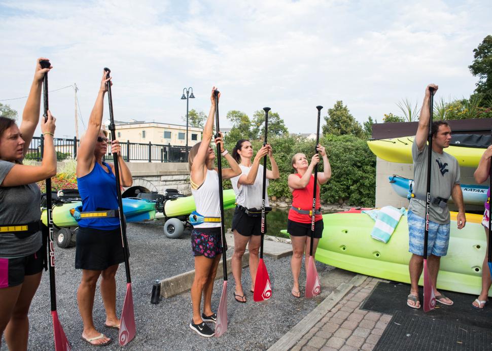 Customers practice for some stand up paddle boarding on Canandaigua Lake