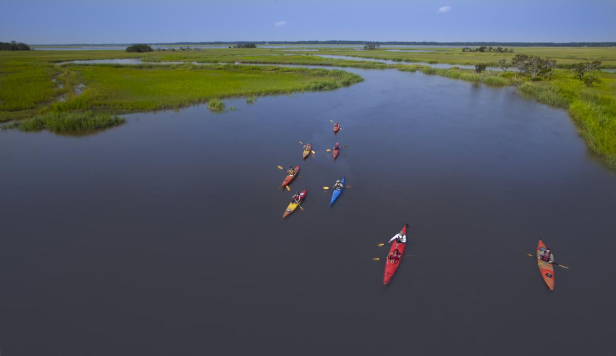 A group of kayakers paddle through the marsh in Golden Isles, Georgia