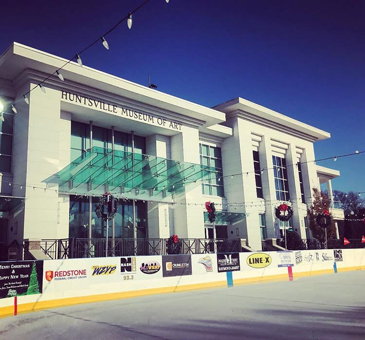 An outdoor skating rink is set up in front of the Huntsville Museum of Art