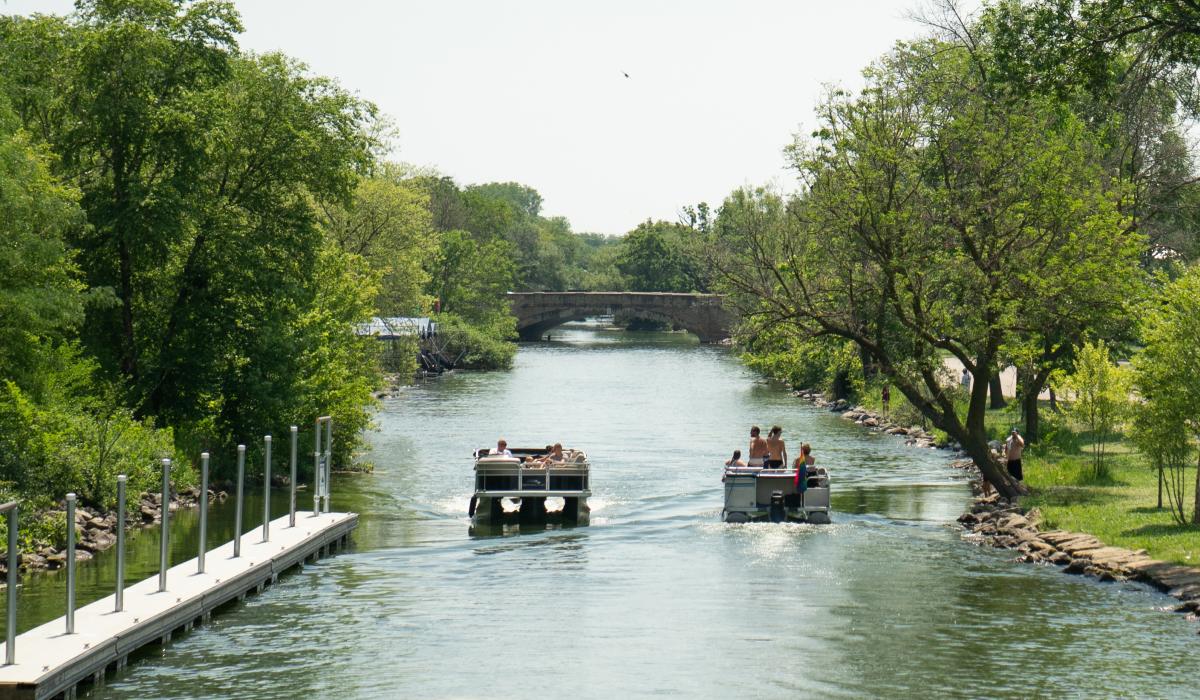 Two boats pass one another on the Yahara River