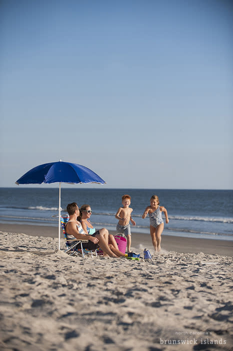 Mom, Dad, Son, and Daughter having fun on the beach