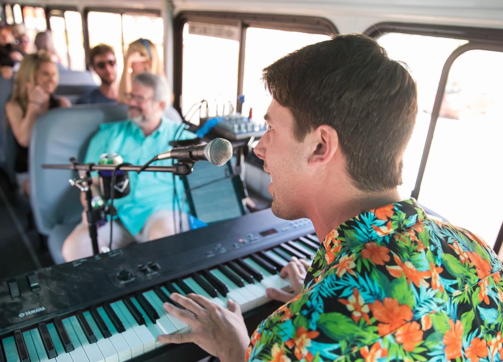 tour guide plays piano and sings on Twisted Texas Tours Live Music Tour in austin texas