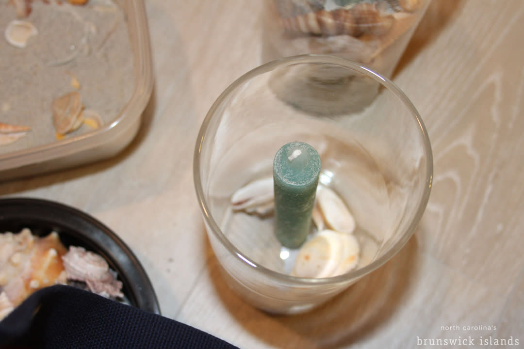 Crafting a candle with seashells