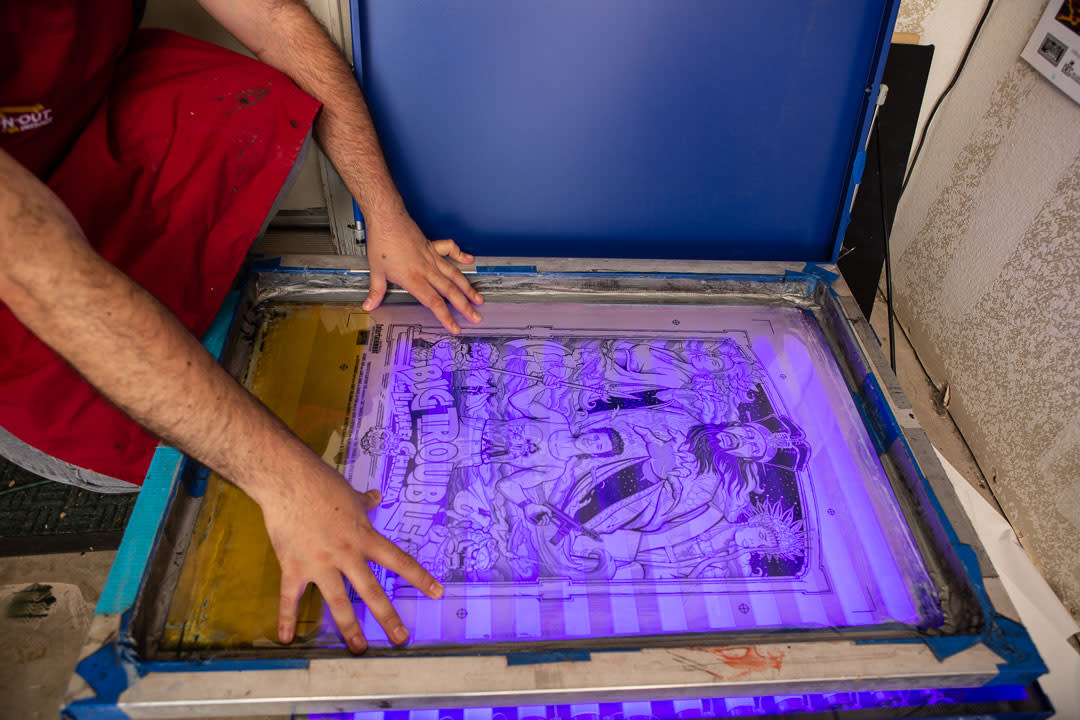Jon Sanchez setting up a screen for printing