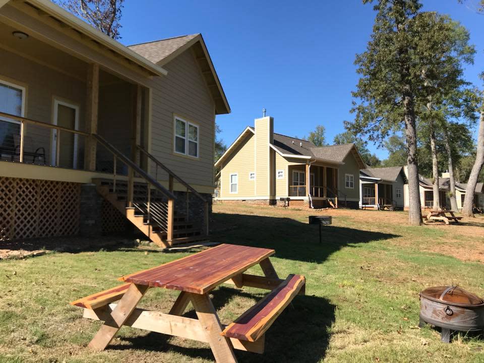 A row of rental cabins near a lake.