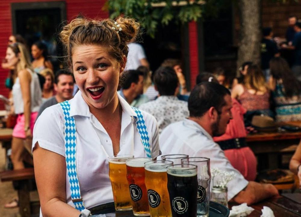 A Waitress carries a tray of beers at the Oktoberfest celebration at Banger's in Austin, Texas