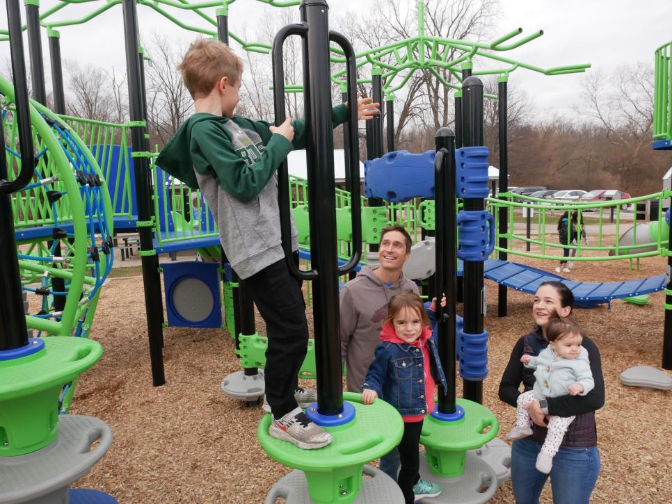 A family plays on the playground at Cool Creek Park in Westfield, IN