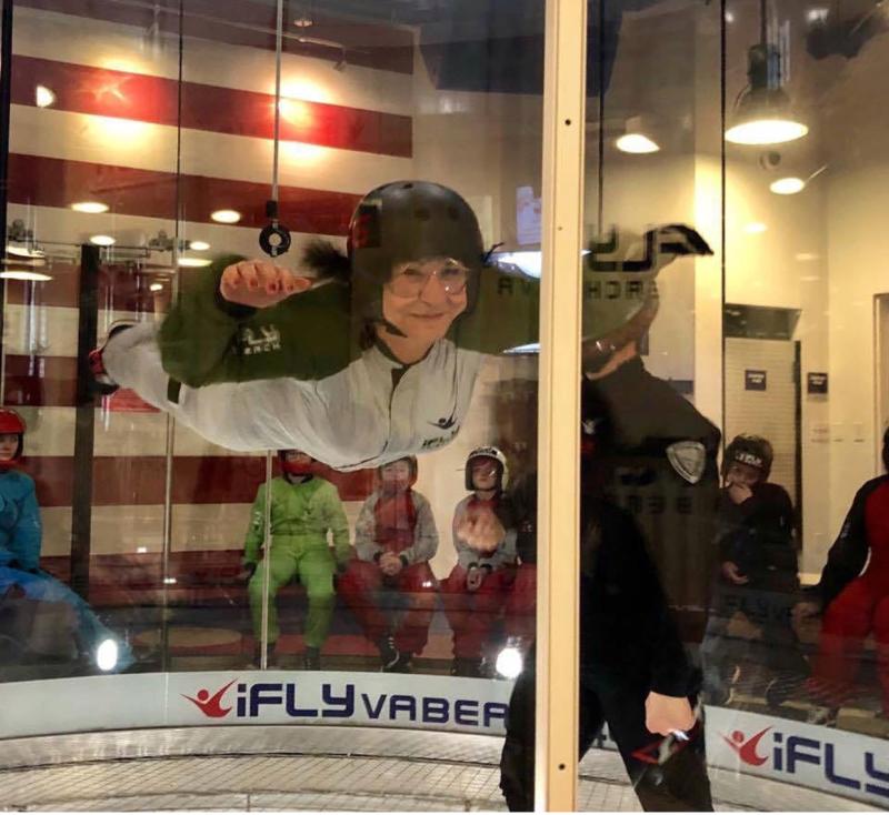 A visitor flashes a smile during their time in the IFly Indoor Skydiving tube.