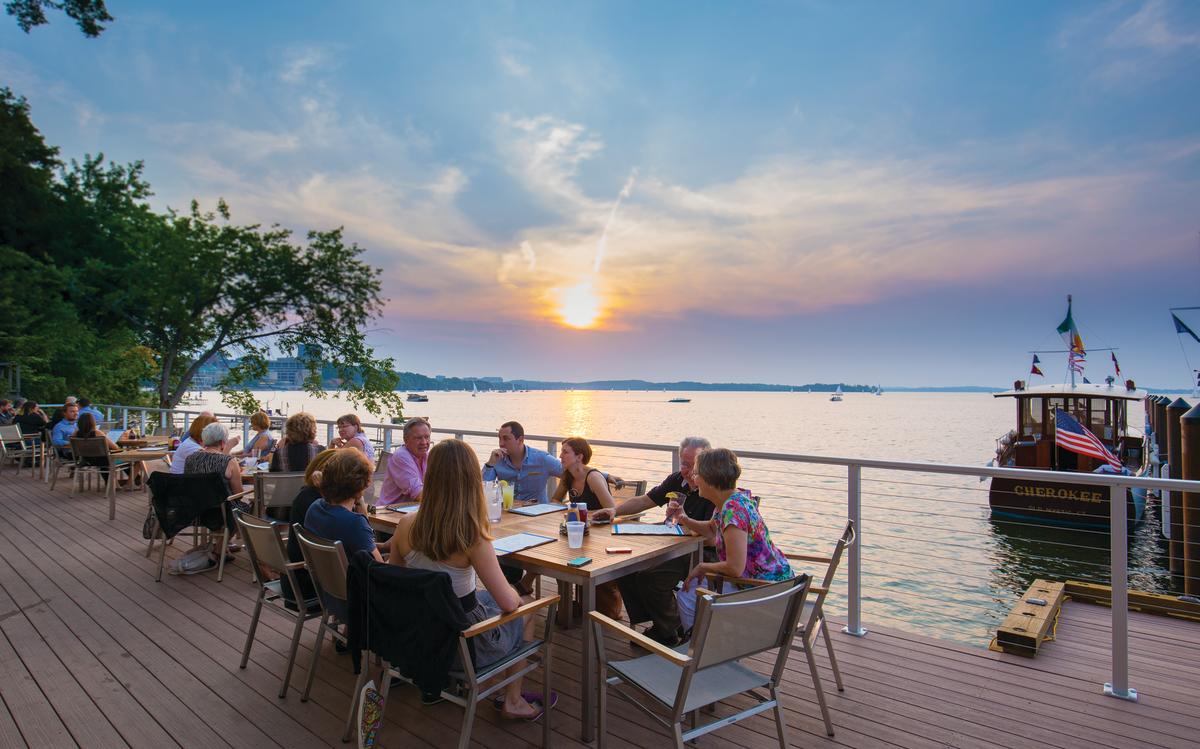 People dining on an outdoor patio at The Edgewater
