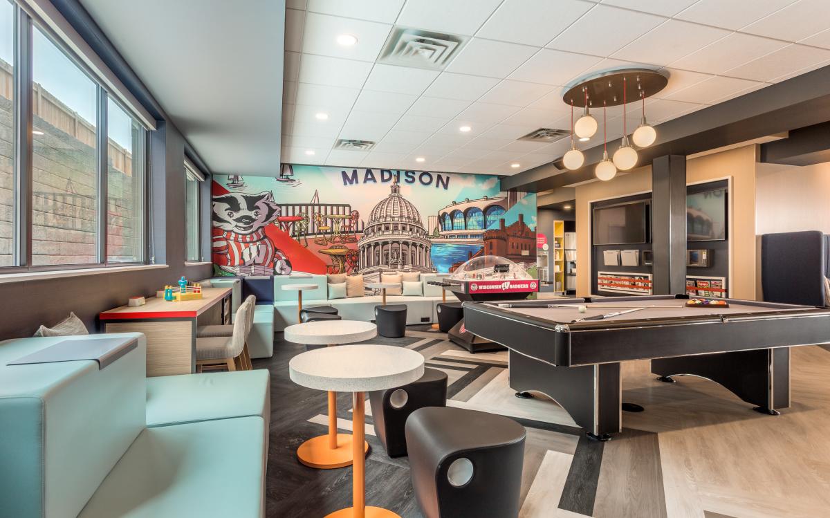 A community room with pool table at Tru by Hilton Madison West