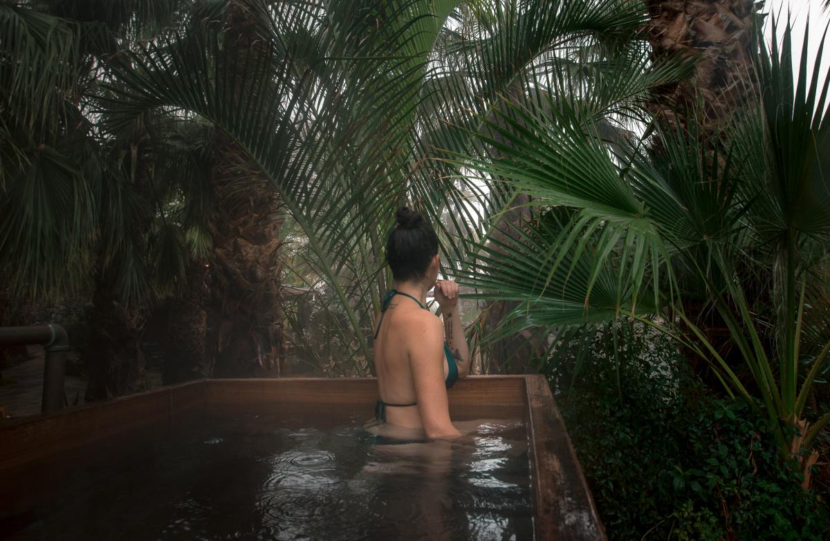 Woman relaxing in natural hot spring at Two Bunch Palms resort in Desert Hot Springs