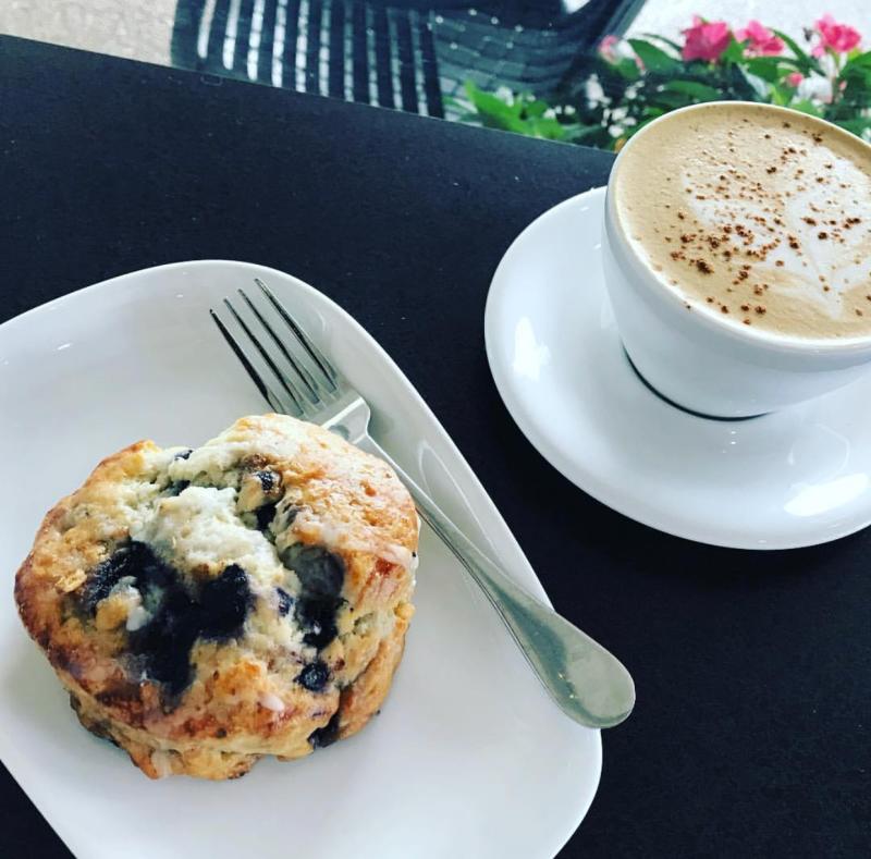 A blueberry muffin goes perfectly with a warm cappuccino from Roast Rider Coffee Cafe