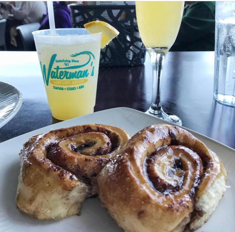 Fresh cinnamon rolls pair well ice-cold drinks from Waterman’s Surfside Grill.