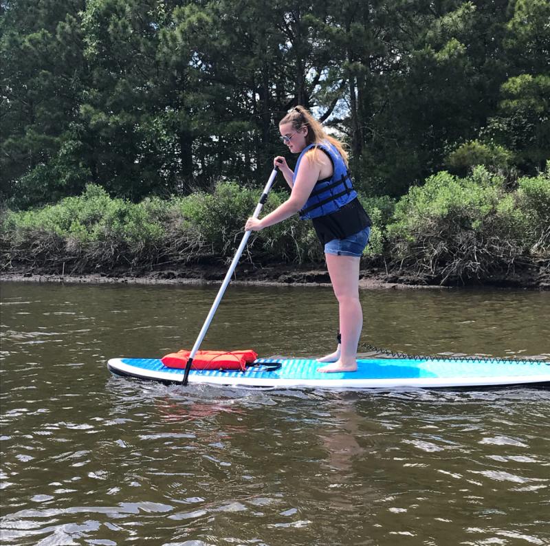 Woman Paddleboarding In Virginia Beach, VA