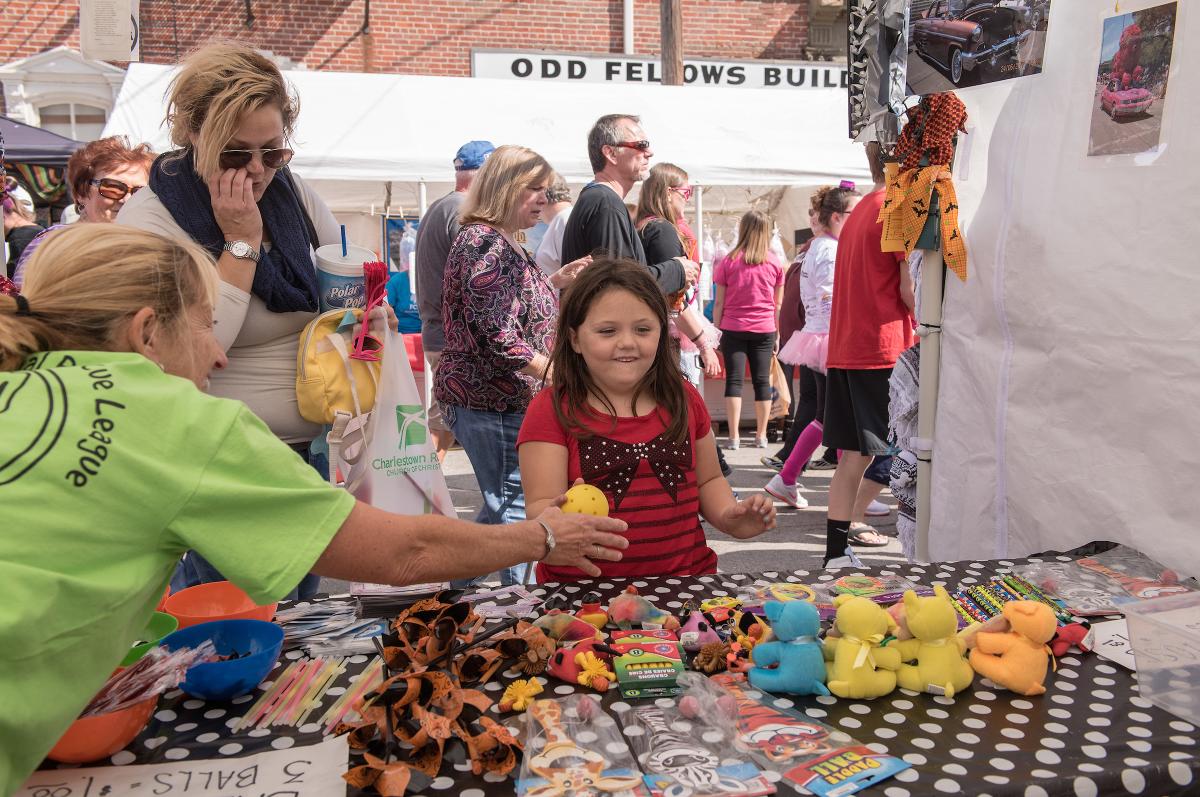 Girl plays a game at a Harvest Homecoming booth.