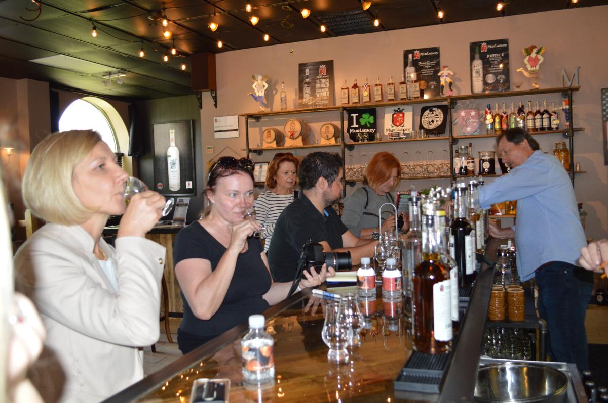 Group sampling spirits at Murlarkey Distillery
